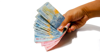 Hand Holding Indonesian Rupiah Banknotes 50000 and 100000 on White Background