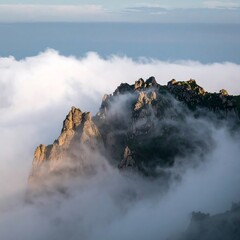 Majestic Mountain Peak Emerging from a Sea of Clouds.