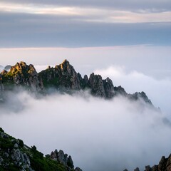Majestic Mountain Peaks Emerge from a Sea of Clouds at Sunrise.