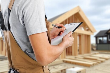 Carpenter constructing wooden frame house construction
