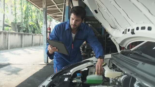 EV car check, Hispanic male mechanic worker inspects and maintains service of electric engine and battery in fixed automobile garage station, professional technology transportation industry business.