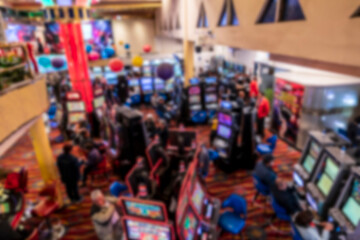 Defocused casino slot machines with colorful neon lights