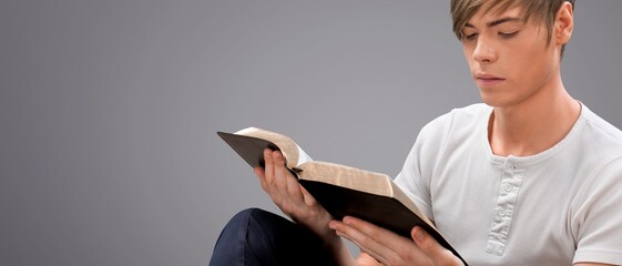 Hands of prayer hold holy bible in church