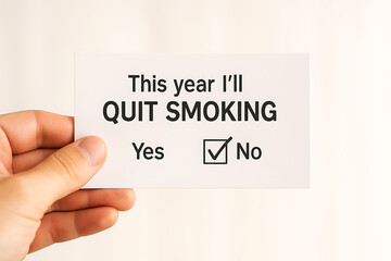 Hand holding card message this year I will quit smoking choice yes no tick box decision unhealthy habit tobacco addiction awareness lifestyle health warning stop cigarette risk prevention motivation r