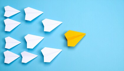 Leadership concept a yellow paper plane leads a group of white planes on blue background. Concept for business leadership, competitive advantage and innovative solutions