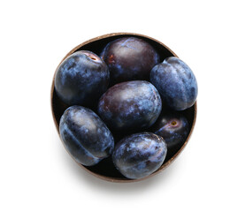 Bowl with ripe plums on white background