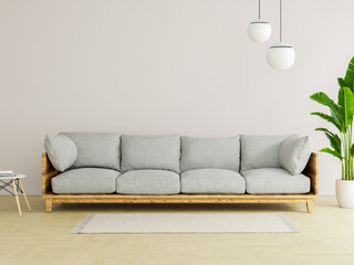Minimalist living room interior with a comfortable grey sofa, a large green houseplant, and modern pendant lights against a blank wall for copy space