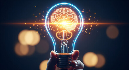 Hand holding lightbulb with brain inside and glowing particles around the bulb