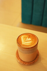 A cup of hot latte coffee on the table for breakfast