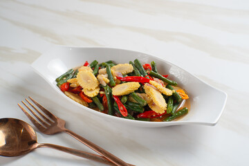 Homemade stir-fried long beans and baby corn. Perfect for recipes, articles or any cooking content.