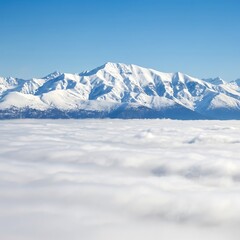 Obraz premium Majestic Snow Capped Mountain Peaks Above Sea of Clouds on a Bright Sunny Day