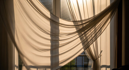 Obraz premium Soft Sheer Curtains Gently Blowing in a Warmly Lit Window.