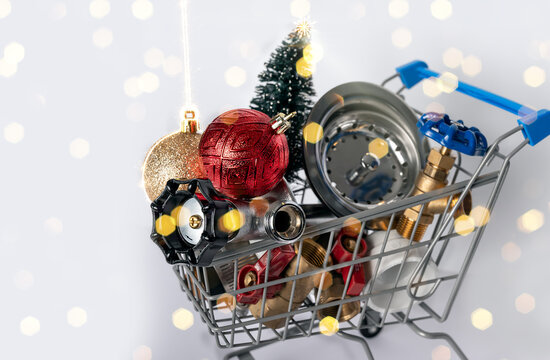 Construction and plumbing tools scene with Christmas and New Year holiday decorations on a shopping cart.