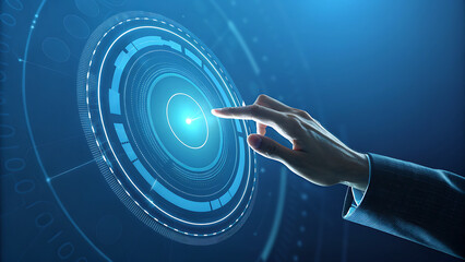 A hand interacts with a futuristic blue holographic interface, touching a glowing circular display with concentric rings, representing advanced technology and data interaction
