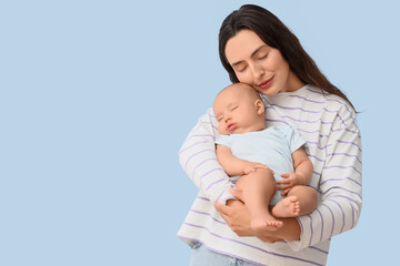 Happy mother with her little baby on light background. IVF concept