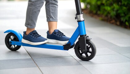 Child riding a blue scooter outdoors