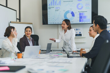 Business team discussing graphs and working together on a project during a meeting in a modern office