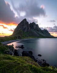 Dramatic mountain vista at sunset over calm water