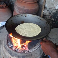 Cooking flatbread over charcoal fire