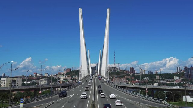 Golden Bridge over Golden Horn Bay in Vladivostok, Russian Far East, with city traffic and modern skyline of Primorsky Krai.
