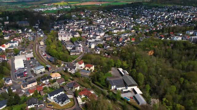 Aerial panoramic view around the old town and palace of the city Hadamar, Germany on a sunny spring morning