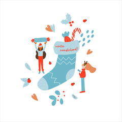 Two miniature elves put candy in a Christmas sock. Winter. New Year. Christmas. 