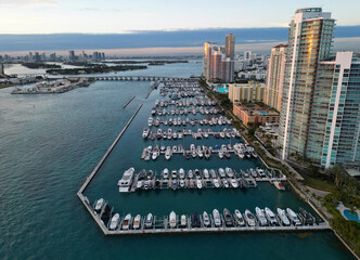 Yacht docked at Miami marina. Aerial view of coastline in Miami. Sailboat cruising along the Miamis...