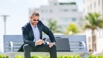Man relax on bench with phone. Hispanic business man with phone. Business communication. Casual...
