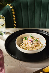 Mushroom risotto in a ceramic bowl, bright natural lighting, overhead composition