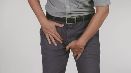 Senior man feeling pain in the Prostate gland or lower abdomen. Symptoms of prostatitis on white background.
