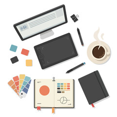 Overhead view of a designer's workspace featuring a computer monitor, graphics tablet, pens, color swatches, notebook, and a steaming cup of coffee, suggesting creative work.