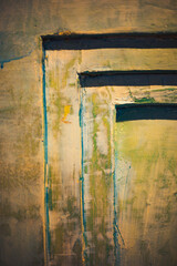 A study in color and form, soft gradients of green and yellow blend seamlessly with stark geometric lines. The layered textures and rough edges create a sense of depth and complexity. The use of contr