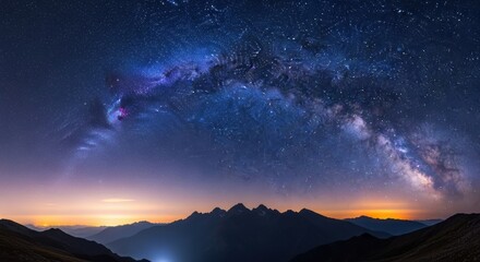 Fototapeta premium Majestic milky way arching over silhouetted mountain peaks under a starry night sky