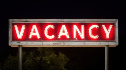 Bright red "VACANCY" sign illuminated at night.