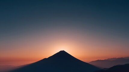 Minimalist mountain silhouette against glowing sunrise