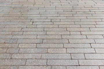 A close-up of stone and other materials, with random shapes arranged in succession to create an interesting design.
