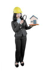 Female Architect Examining a House Miniature with a Magnifying Glass