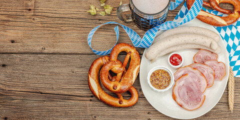 Traditional Oktoberfest set. Pretzels, beer, weisswurst, eisbein with mustard. German festival food