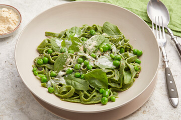 Homemade spinach pasta with creamy sauce