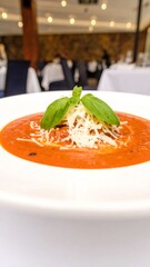 Creamy tomato soup with basil and cheese