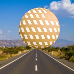 Tan sphere floats over a highway