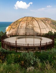 Dome structure on a hill overlooking the sea