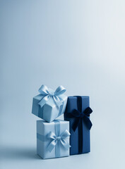 Icy Blue and Silver Gift Box Stack with Velvet Ribbons on Gradient Winter Background