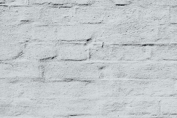 Cracked white painted brick wall for damaged building and repair concept