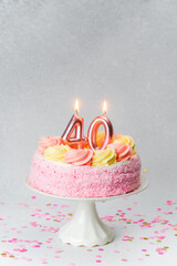 Celebration cake with candles marking 40 years of life on a festive table
