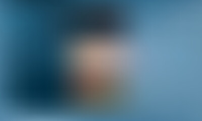 Woman in profile looking out window, thoughtful gaze on blue background