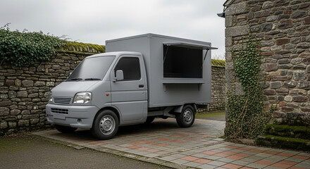 Gray Food Truck Parked on a Brick Driveway, Ready for Business
