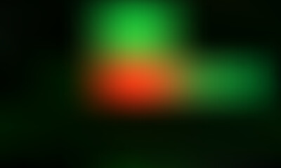 Abstract glowing bokeh lights in vibrant red and green hues against a dark background, creating a festive and magical atmosphere.