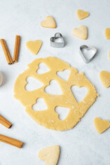 Heart cookie dough baking with cinnamon on marble surface for recipe, valentine or lifestyle concept