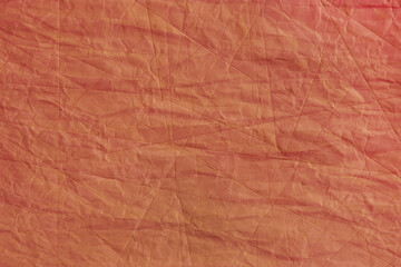 Fototapeta premium Abstract wrinkled orange crumpled paper texture background